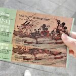 person holding brown and green book