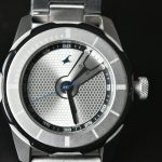 a close up of a watch on a black surface