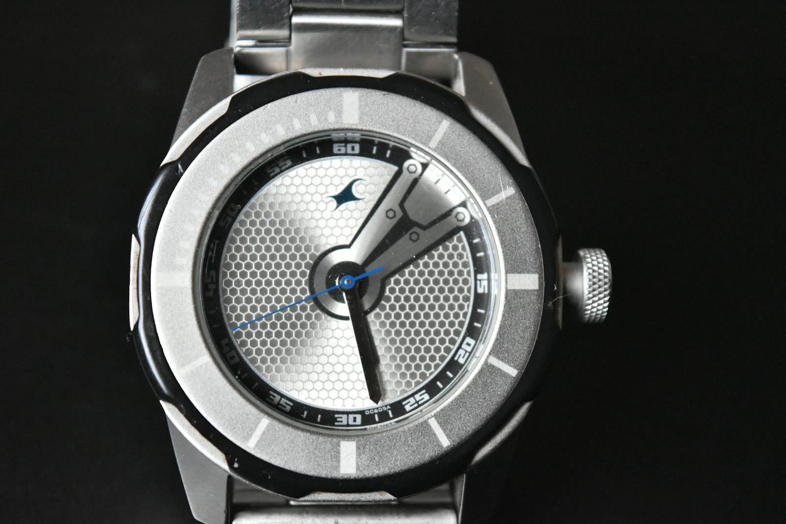 a close up of a watch on a black surface